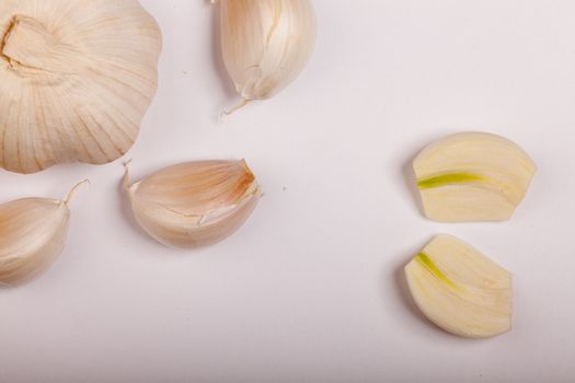 some whole and cut garlic leaving copyspace