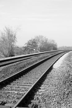 Vertical monochrome take of a bent railroad track