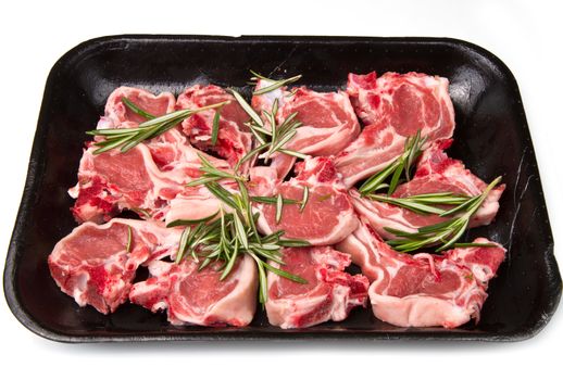 Racks of lamb, ready for cooking, with fresh rosemary