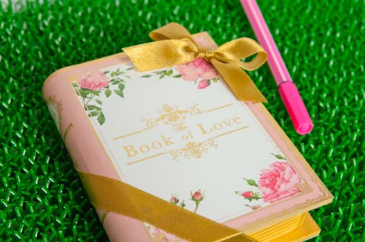 the book of love on green background