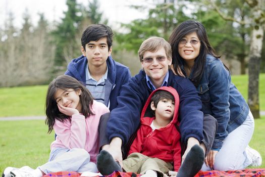 Happy interracial family enjoying a day at the park