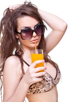 beautiful women in swimsuit with a glass of juice on a white background isolated