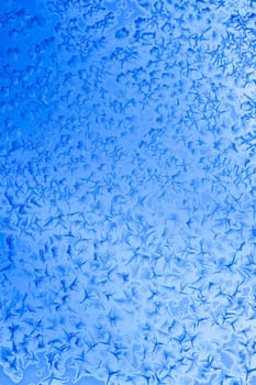 Frost patterns on window glass in winter