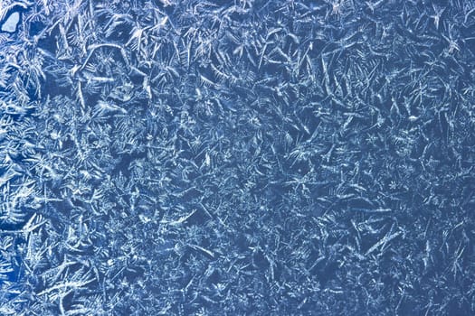 Frost patterns on window glass in winter