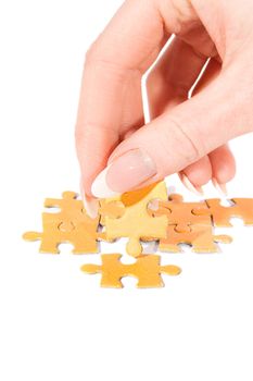 Woman hand putting right piece in puzzle
