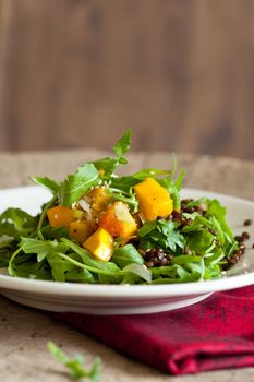 Delicious roasted pumpkin salad with rocket and lentils