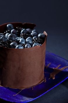 Delicious chocolate cake with blue berries and black berries