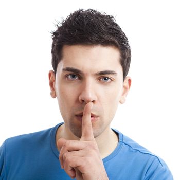 Portrait of a young man asking for silence, isolated on white background