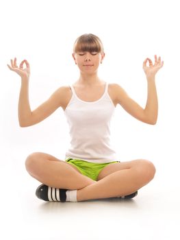 Young girl meditating in the lotus pose