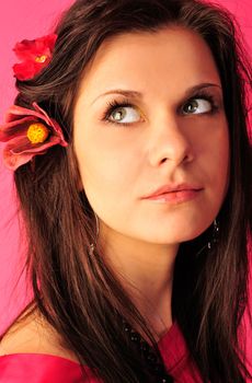 Portrait of a young beautiful woman over pink background