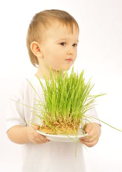 little boy with green grass  isolated on white