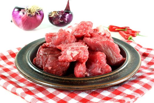 a plate of fresh raw beef goulash