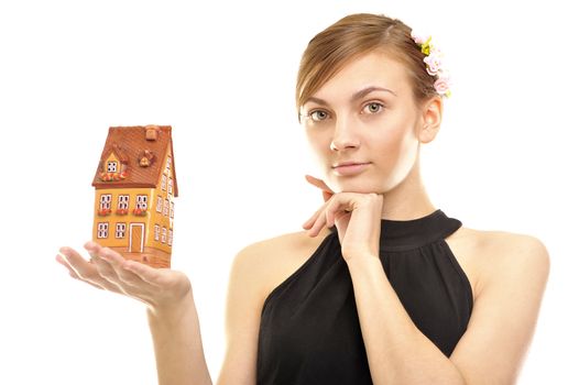  Concept image of a woman holding house isolated on white