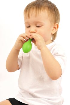 Nice little boy  blowing up a balloon 