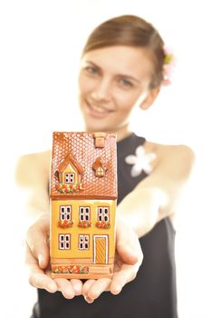 Concept image of a woman holding house isolated on white