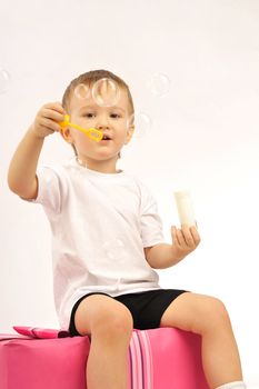  Nice little boy  blowing up soap bubbles     