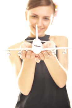  young woman holding a plane isolated on white