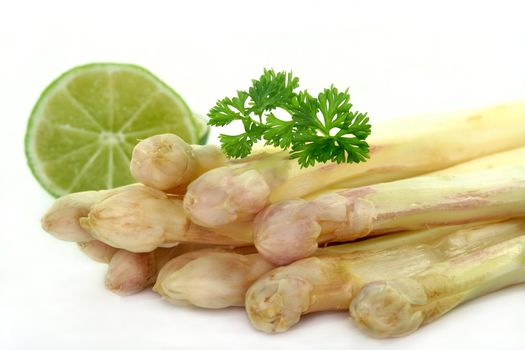 a bundle of fresh asparagus on a white background