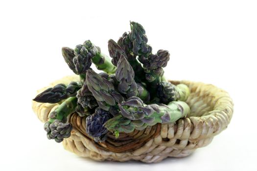 a bundle of green asparagus in a basket