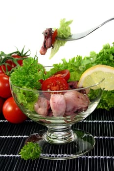 Octopus salad with fresh vegetables and herbs