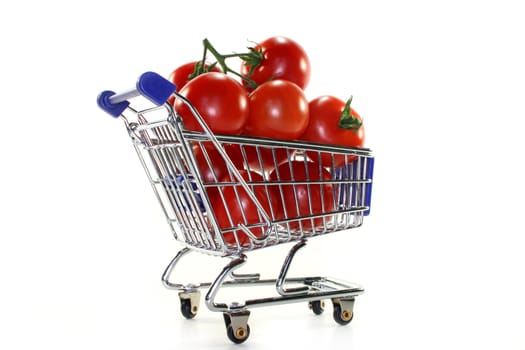 a shopping cart filled with fresh tomatoes