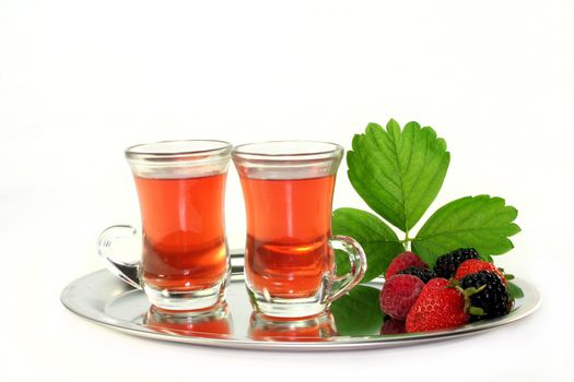 two cups of forest fruit tea with fresh fruit