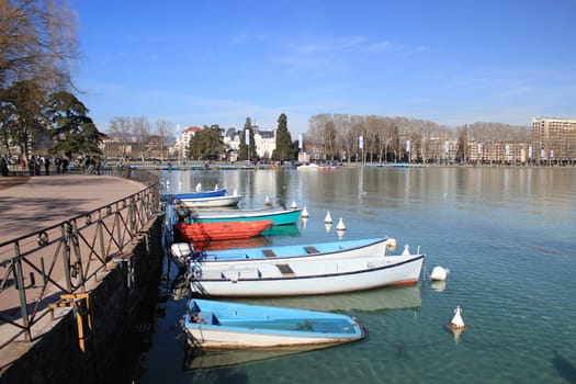 Small wood boats on the Annecy lake, France, by beautiful weather