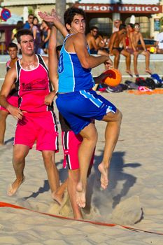 CADIZ, SPAIN - JULY 19: Unidentified players compete in a match between Zonabalonmano.com and CadizSur Seguros BMPY in the 19th league of beach handball of Cadiz on July 19, 2011 in Cadiz, Spain