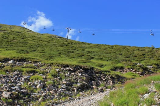 Chair lifts in the mountain by summer beautiful day, France