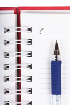 Macro view of blank spiral notebook and pen