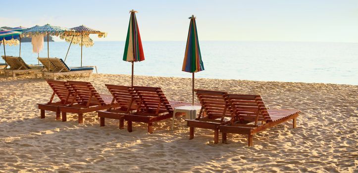 Group of wooden sunbeds on the beach the evening