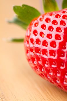 Closeup of ripe strawberry on wooden background