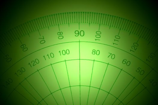 Close Up capturing a portion of a transparent plastic protractor arranged over deep green light effect