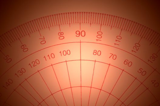 Close Up capturing a portion of a transparent plastic protractor arranged over red light effect filter