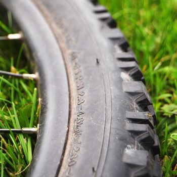 mountain bike offroad tire in green grass showing sport in nature concept
