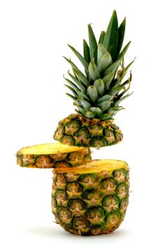 Pineapple with slice floating in the air on white background