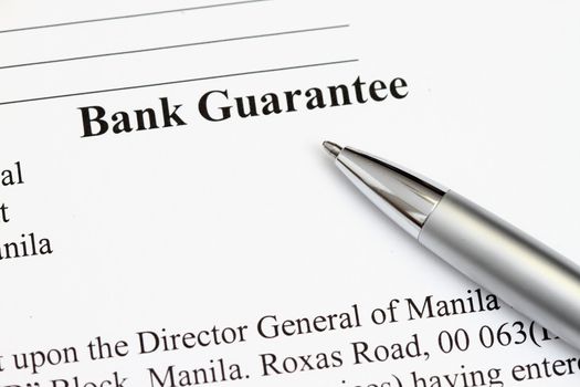 Macro shot of Bank Guarantee with pen in focus - many uses in finance and banking.