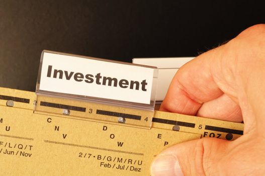 investment word on business folder showing financial success concept