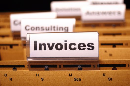 invoice or invoices concept with business folder in office showing paperwork