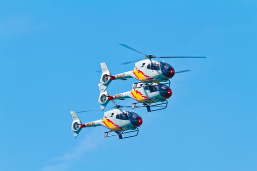 CADIZ, SPAIN-SEP 11: Helicopters of the Patrulla Aspa taking part in an exhibition on the 4th airshow of Cadiz on Sep 11, 2011, in Cadiz, Spain