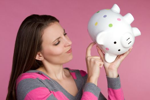 Young woman holding piggy bank