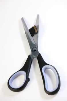 Scissors cuts usb flash memory, isolated on white backround
