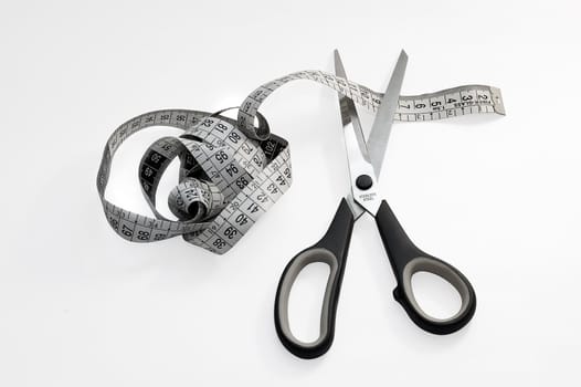 Meter studio and cutting scissors. Illustrate to proverb "look before you leap; better safe than sorry"