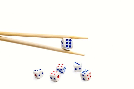 Chopsticks and dices on white background