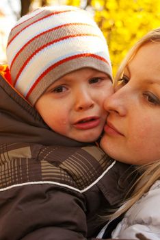 Mom holding little crying boy