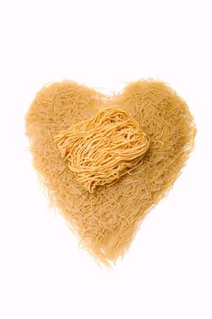 Noodles as heart on white background 