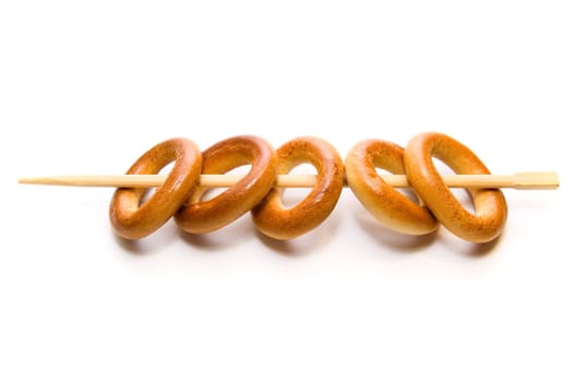 Bread rings on chopstick on white background