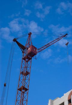 Photo of a tower crane on sky background