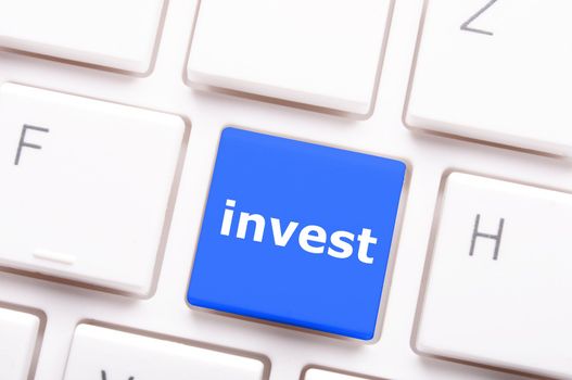 invest key on keyboard showing financial business investment concept