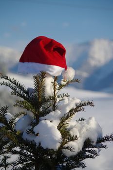 red santa claus hats in a snowy landscape